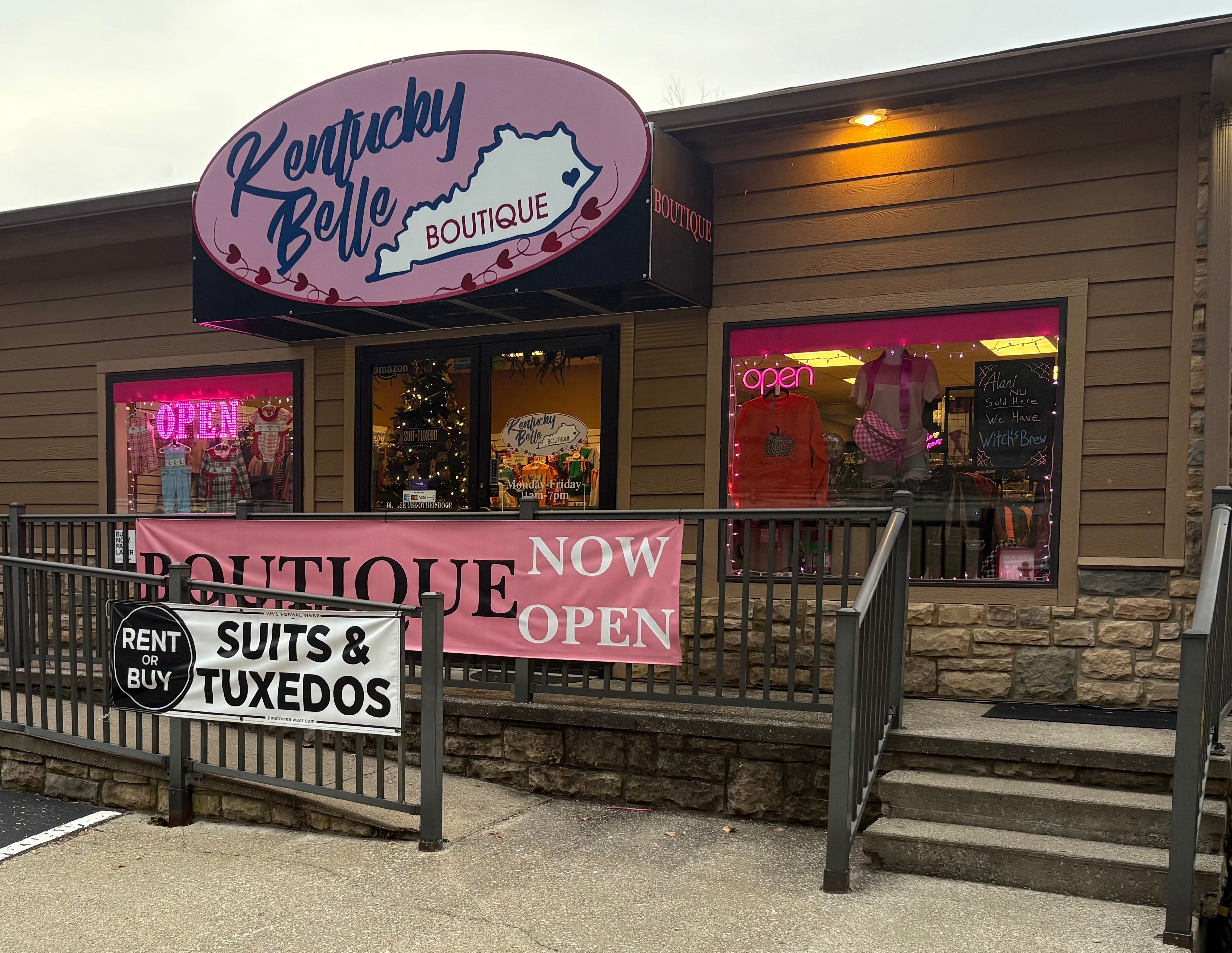 Kentucky Belle Boutique storefront with signs advertising clothing items and a boutique.